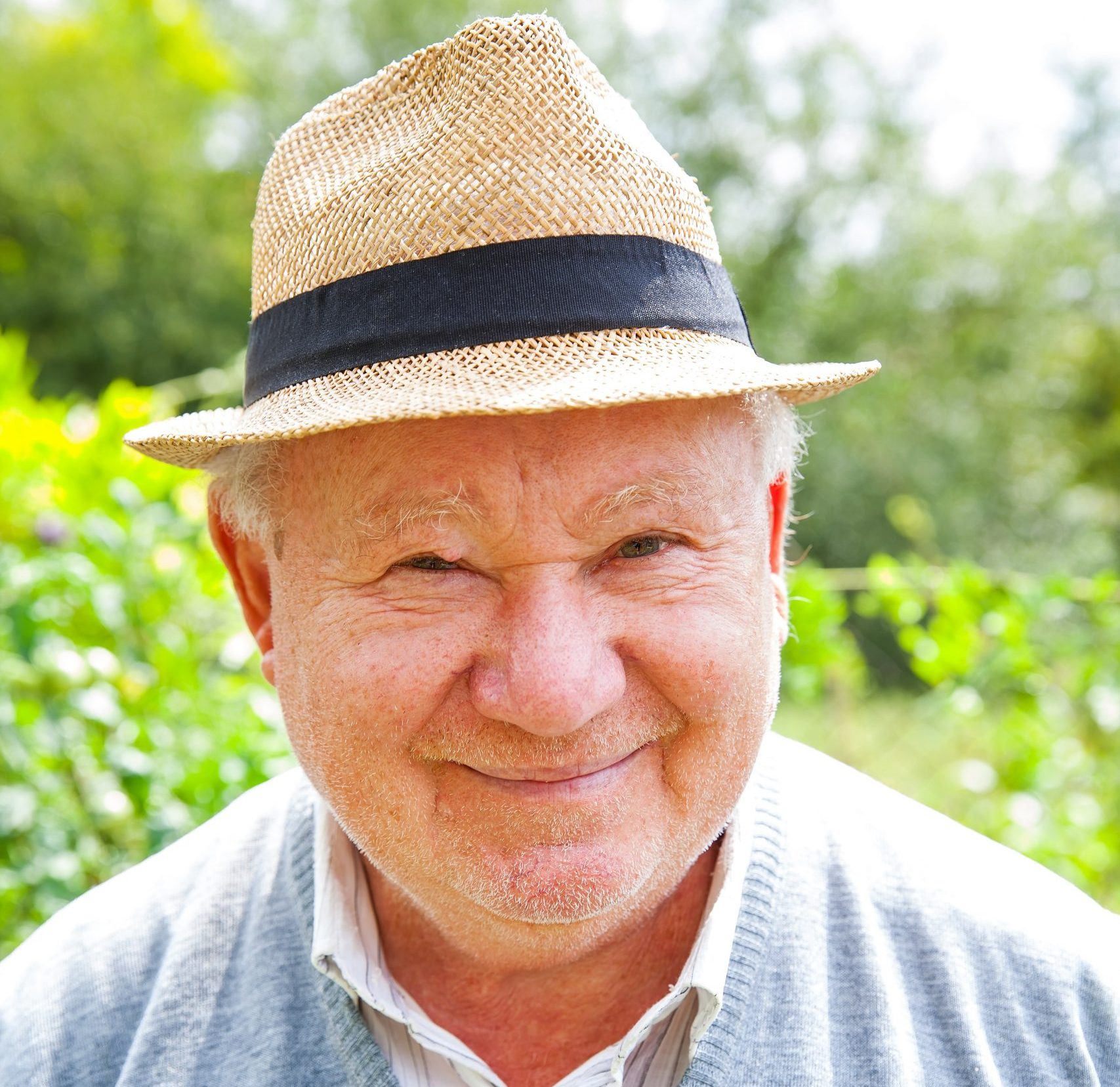Happy old man smiling at the camera