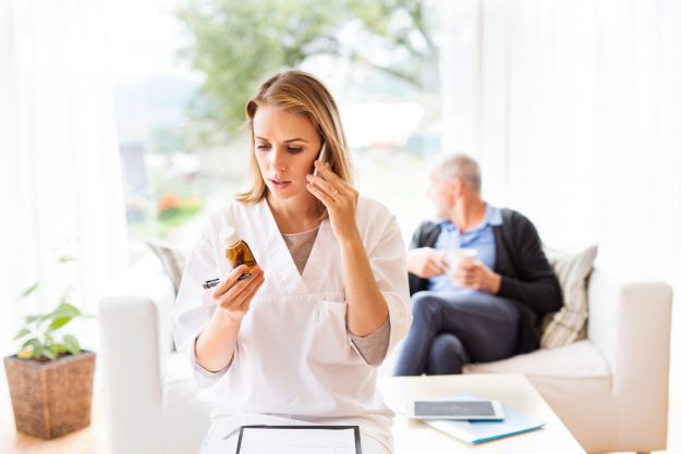 Long-distance caregiving Health visitor with smartphone and a senior man during home visit. A female nurse or a doctor making a phone call. long-distance caregiving concept