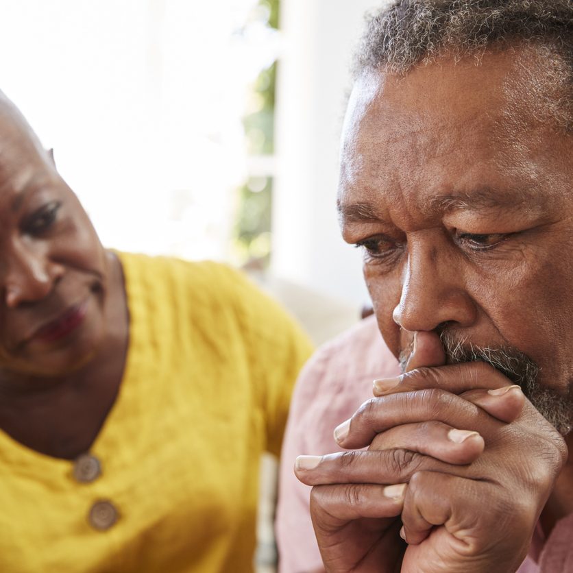 Senior Woman Comforting Man With Depression At Home elderly depression after holidays