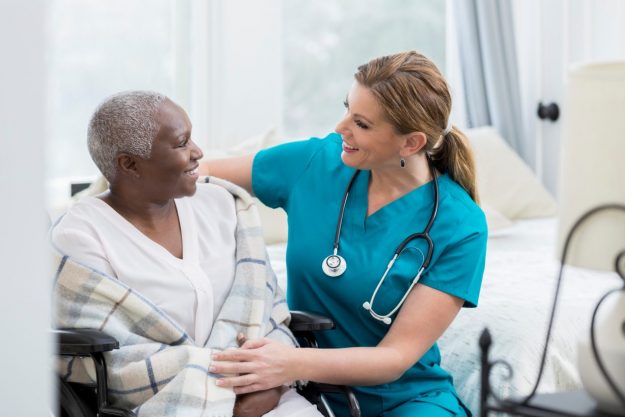 Caring Nurse With Senior Patient In Brooklyn Heights Geriatric hospital admissions in Brooklyn Heights.