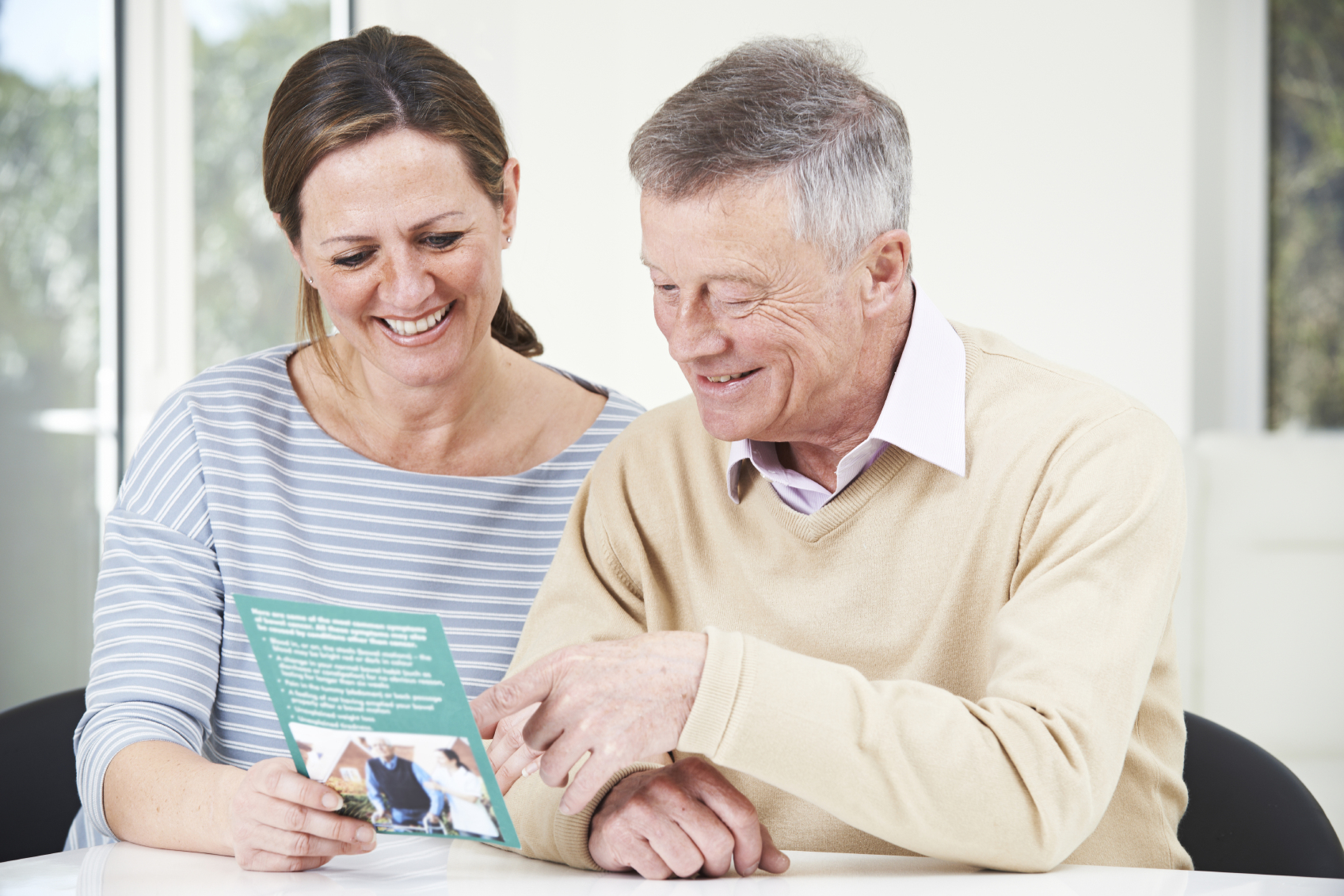 Senior Man With Adult Daughter Looking At Brochure For Retiremen Write an Eldercare Plan for Eldercare Services in Manhattan