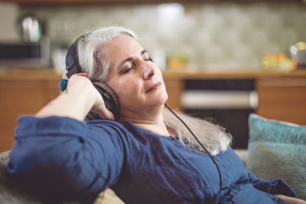 Senior woman at home in Brooklyn, enjoying fun shelter-at-home activities for seniors.