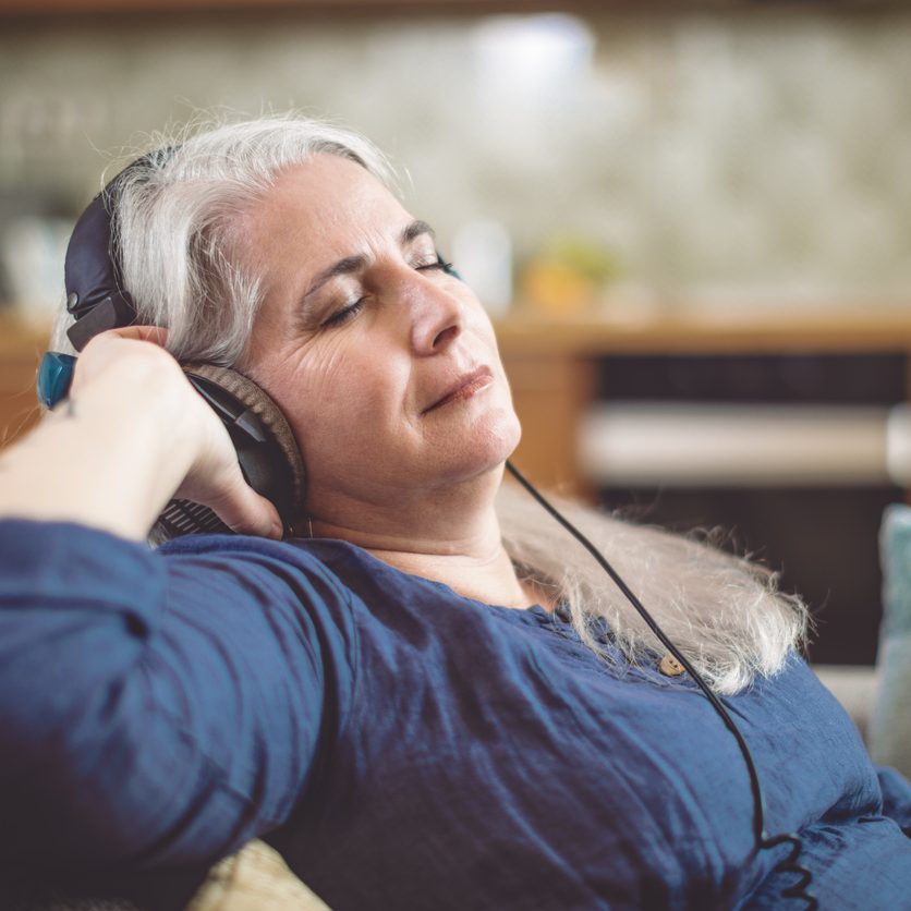 Senior woman at home in Brooklyn, enjoying fun shelter-at-home activities for seniors.