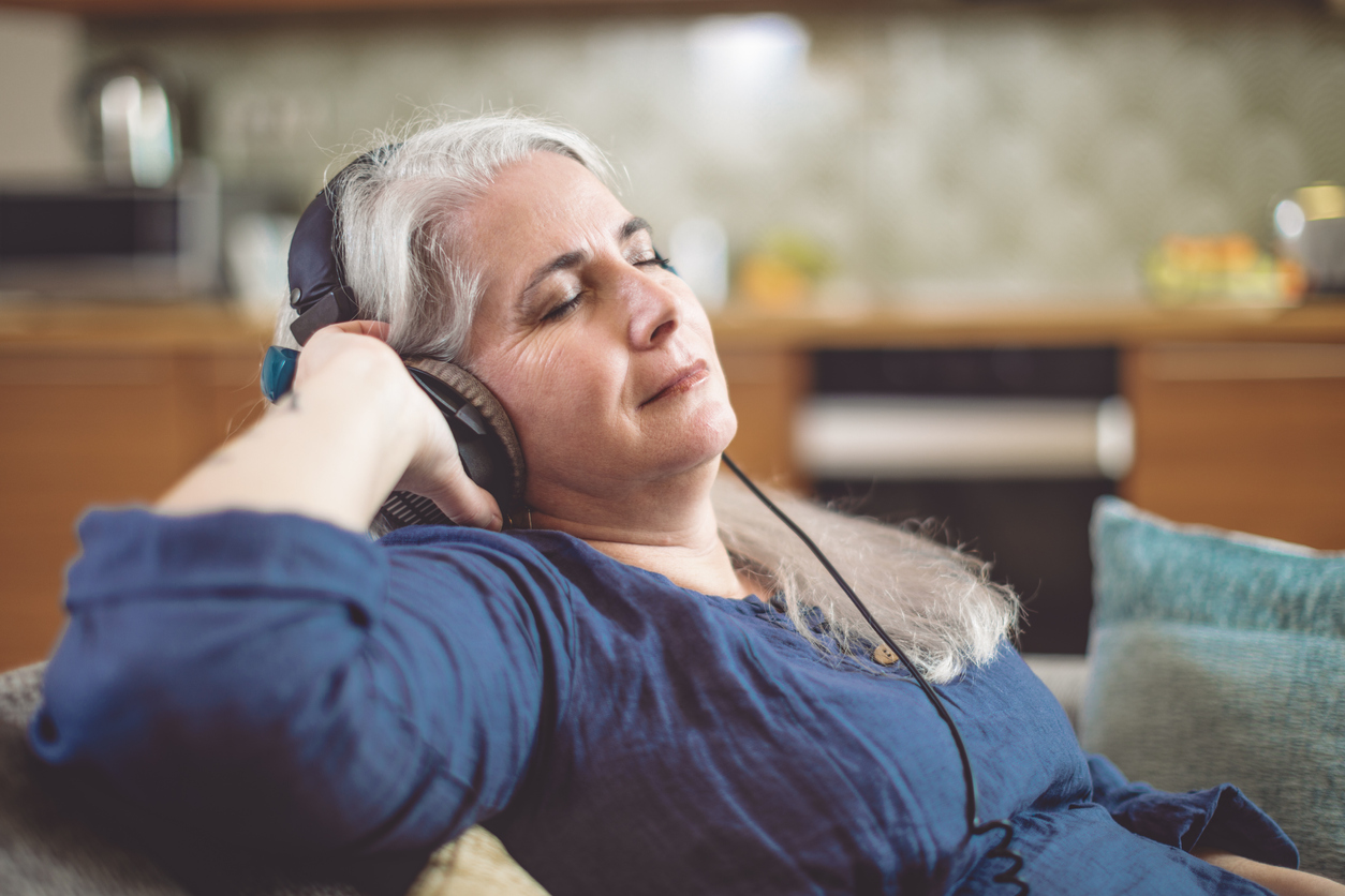 Senior woman at home in Brooklyn, enjoying fun shelter-at-home activities for seniors.