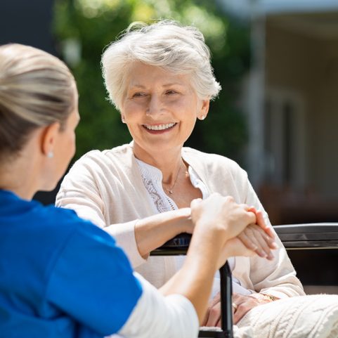 A nurse tending to female patient in Manhattan; happy senior patient who has found a solution to urinary incontinence.
