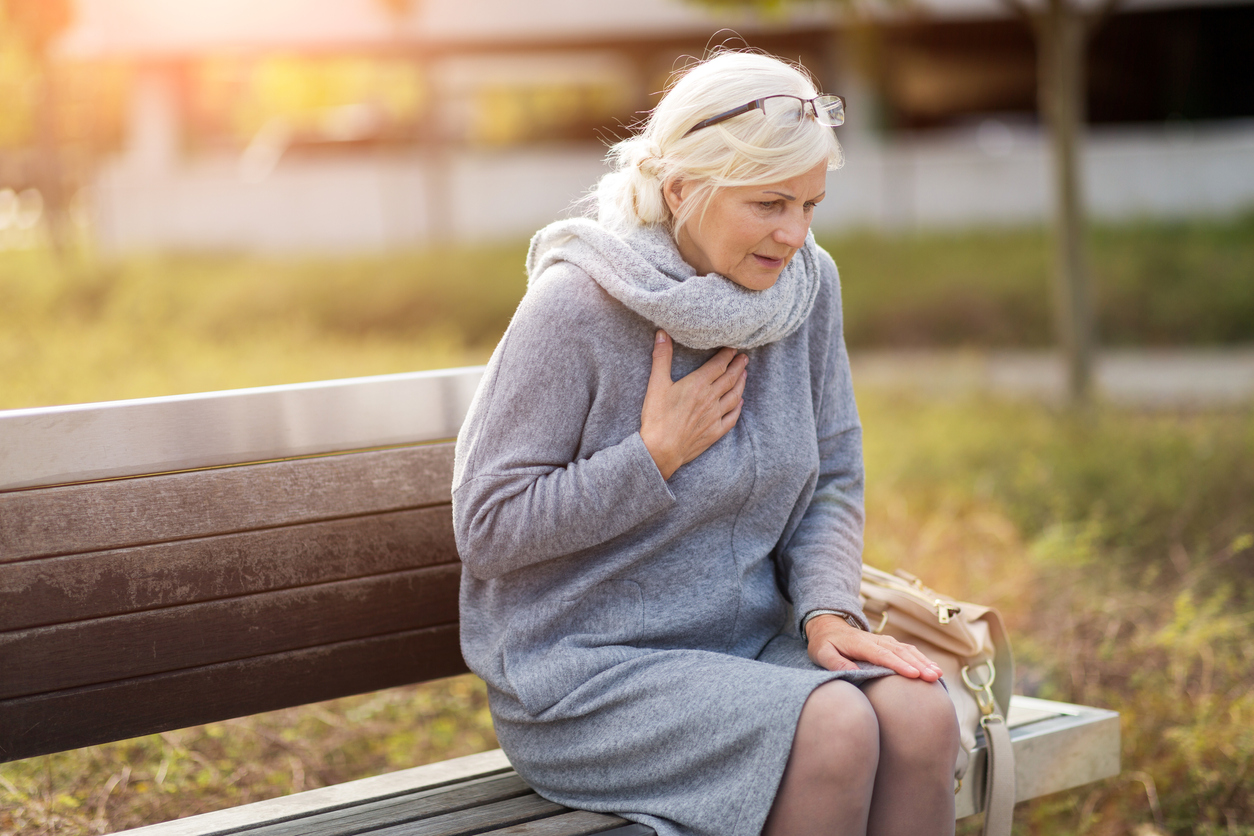 A senior woman experiences sudden cardiac arrest while sitting on a park bench.
