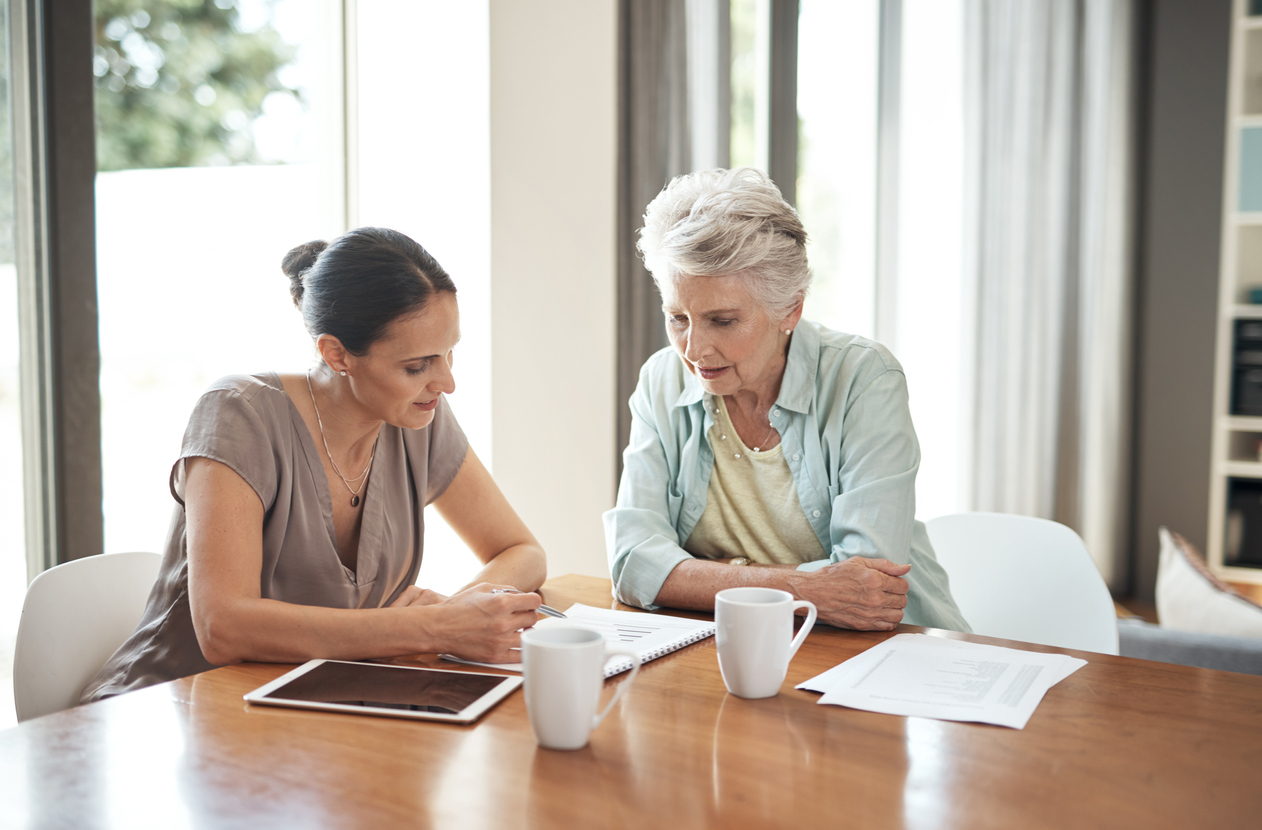 A daughter helps her mother gather documents for eldercare planning.